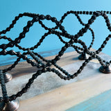 Bicycle Chain wine rack angled view showing layered bike chain slots
