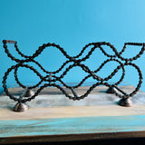 Bicycle Chain wine rack front view with wavy bike chain bottle slots