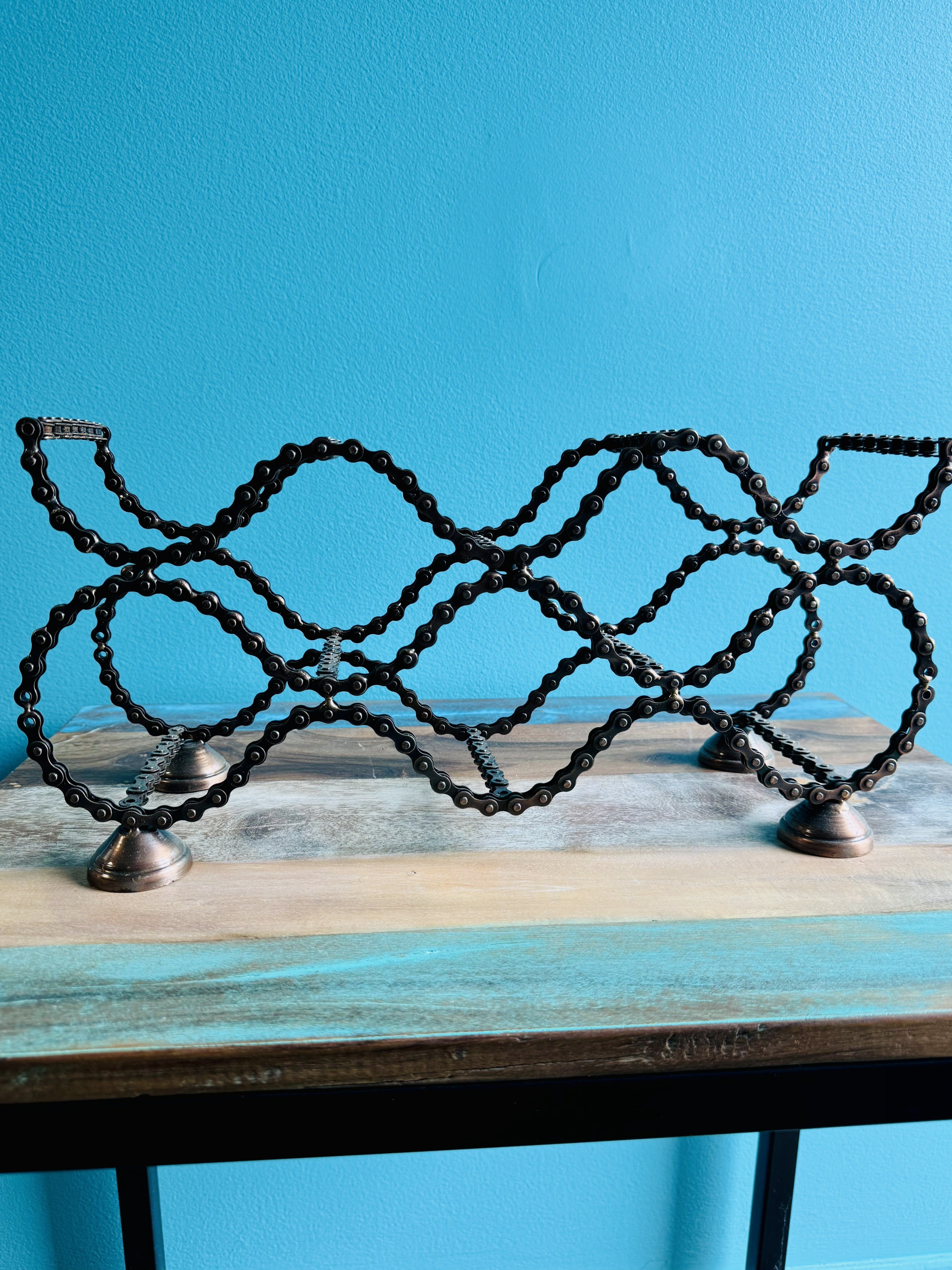 Bicycle Chain wine rack front view with wavy bike chain bottle slots