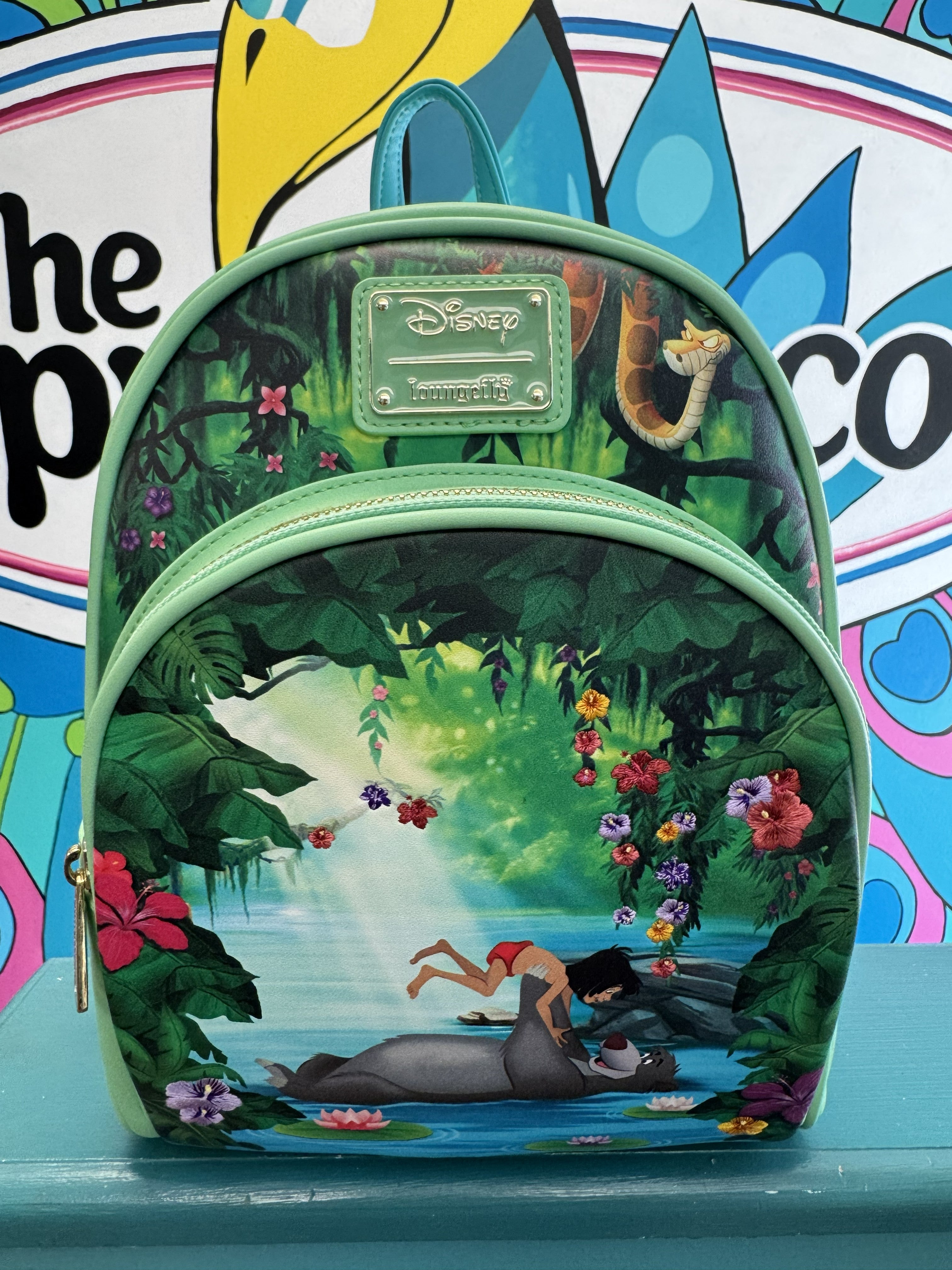 Loungefly Jungle Book mini backpack front view with Mowgli and Baloo river scene